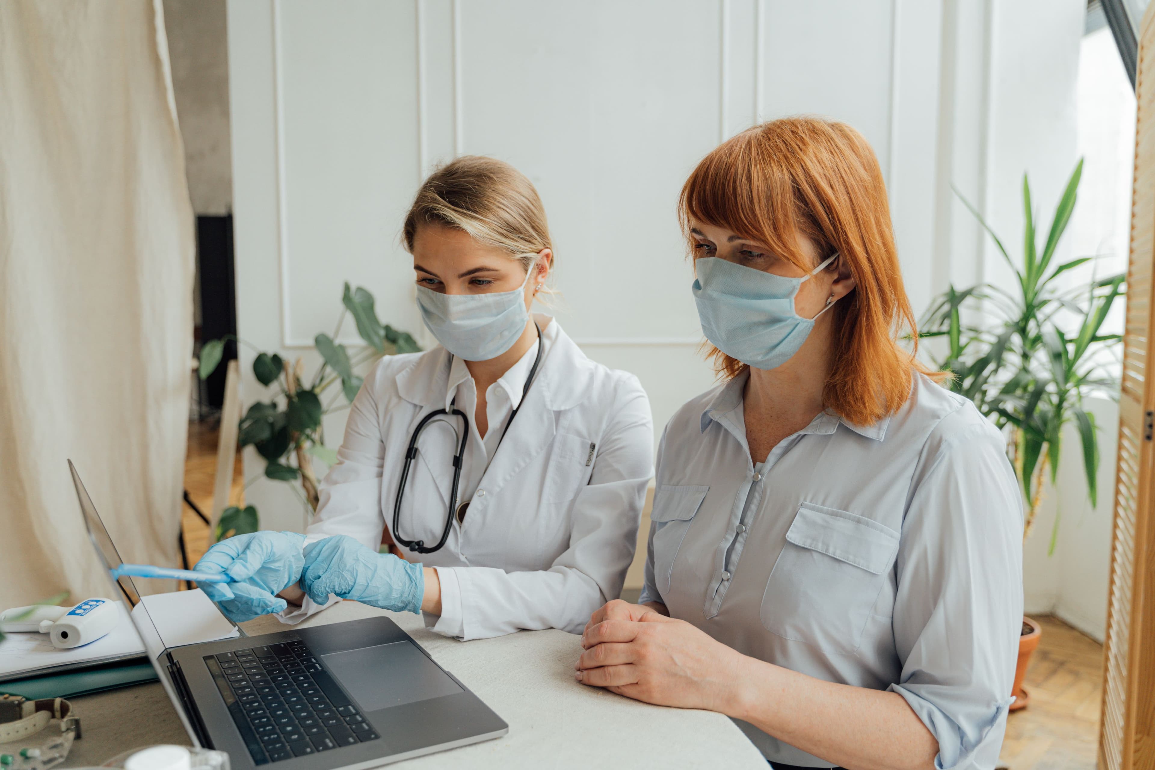 An NYC Health + Hospital / District doctor reviewing a patient's chart